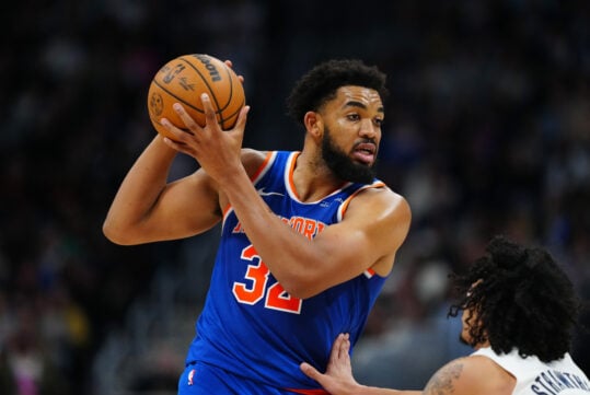 Nov 25, 2024; Denver, Colorado, USA; New York Knicks center Karl-Anthony Towns (32) controls the ball over Denver Nuggets guard Julian Strawther (3) in the second half at Ball Arena. Mandatory Credit: Ron Chenoy-Imagn Images