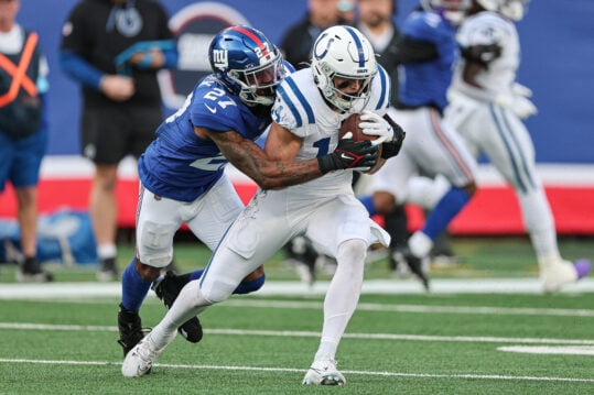 Dec 29, 2024; East Rutherford, New Jersey, USA; Indianapolis Colts wide receiver Alec Pierce (14) makes a catch asNew York Giants safety Jason Pinnock (27) tackles during the first half at MetLife Stadium. Mandatory Credit: Vincent Carchietta-Imagn Images