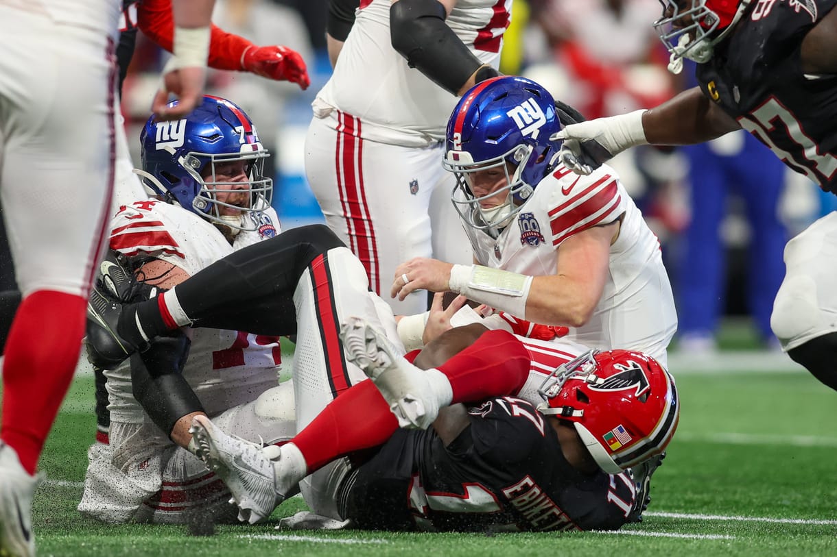 Dec 22, 2024; Atlanta, Georgia, USA; New York Giants quarterback Drew Lock (2) is sacked by Atlanta Falcons linebacker Arnold Ebiketie (17) in the second quarter at Mercedes-Benz Stadium. Mandatory Credit: Brett Davis-Imagn Images