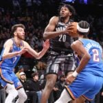 Feb 26, 2025; Brooklyn, New York, USA; Brooklyn Nets center Day'Ron Sharpe (20) looks to drive past Oklahoma City Thunder forward Chet Holmgren (7) and guard Shai Gilgeous-Alexander (2) in the third quarter at Barclays Center. Mandatory Credit: Wendell Cruz-Imagn Images